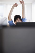 Korean woman stretching at desk