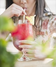 Korean woman drinking tropical cocktail
