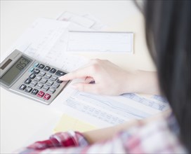 Korean woman using calculator