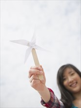 Korean woman holding paper pinwheel