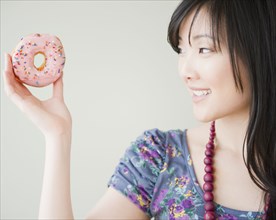 Korean woman holding donut