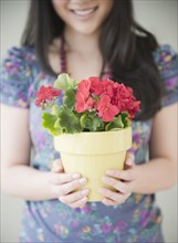 Korean woman holding potted plant