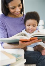 African American woman reading to baby boy