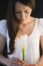 Brazilian woman holding calla lily