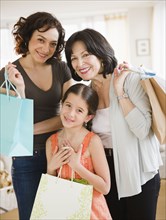 Family holding shopping bags