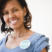 Black woman wearing volunteer badge