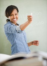 Black woman teaching in classroom