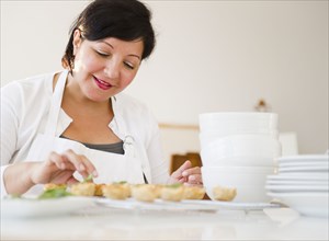 Smiling Hispanic woman baking