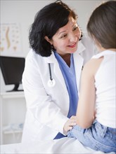 Hispanic doctor talking to patient