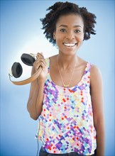 Black woman holding headphones