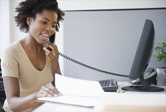 Black businesswoman talking on telephone