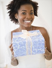 Black bride holding wedding gift