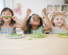 Girls playing with green beans