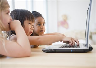 Girls using laptop together