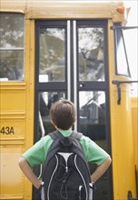 Caucasian boy waiting for school bus