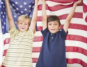 Boys holding American flag together