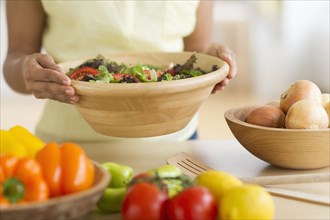 Hispanic woman preparing salad