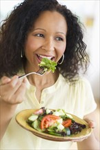 Hispanic woman eating salad