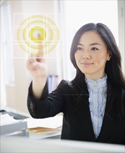 Japanese businesswoman touching digital screen