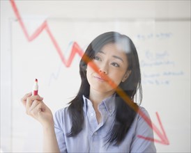 Japanese businesswoman drawing red arrow