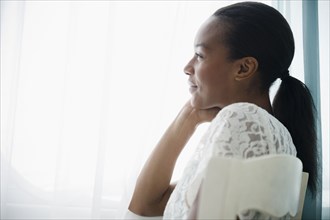 Smiling Black woman thinking