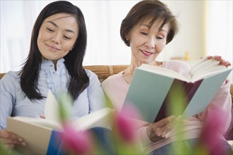 Japanese mother and daughter reading books