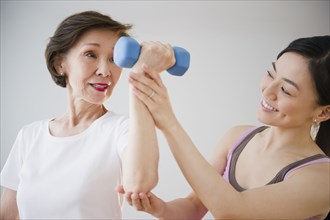 Japanese daughter helping mother with exercise