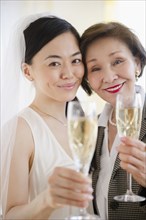Japanese bride and mother drinking Champagne