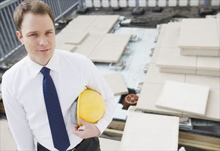 Caucasian businessman standing at construction site