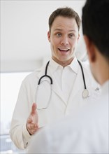 Caucasian doctor talking to co-worker