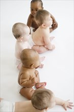 Babies sitting together on floor