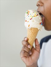 Black boy licking ice cream cone