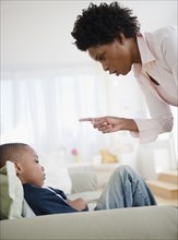 Black mother scolding son