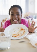 Black girl holding empty plate