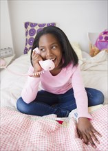 Black girl talking on telephone