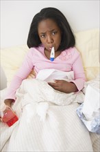 Sick Black girl taking temperature