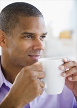 Mixed race man drinking coffee