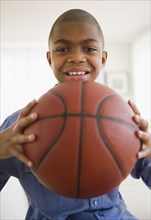 African American boy holding basketball