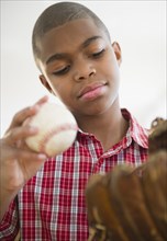 African American boy holding baseball
