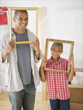 Father and son looking through empty frames