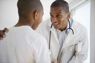 Doctor talking to African American boy