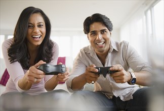 Mixed race couple playing video game