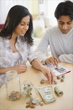 Mixed race couple counting money