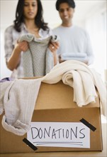 Mixed race couple donating clothing