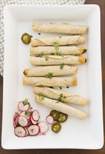 Mexican taquitos on platter