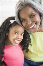 Smiling African American grandmother and granddaughter