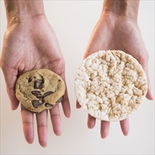 Cape Verdean woman holding cookie and rice cake