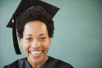 African American woman in graduation cap and gown