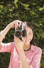 Asian woman taking photographs