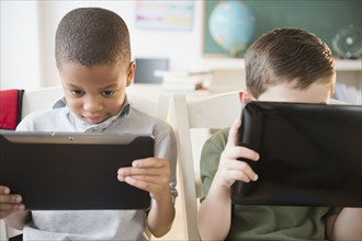 Students using digital tablets in classroom